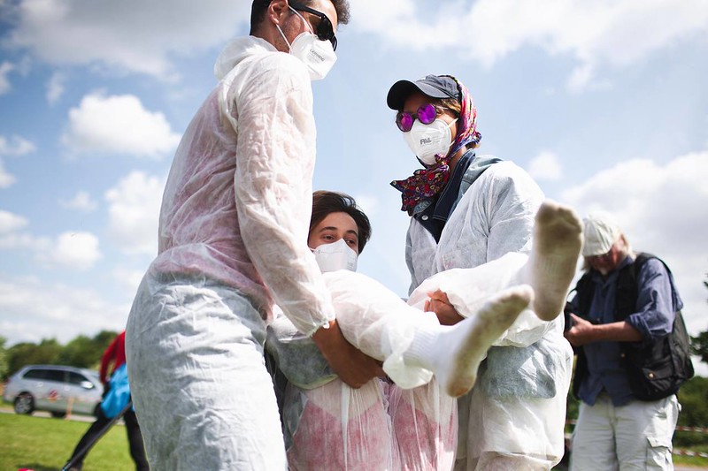 The picture shows two people carrying away a third person. which is a classic exercise in action training.